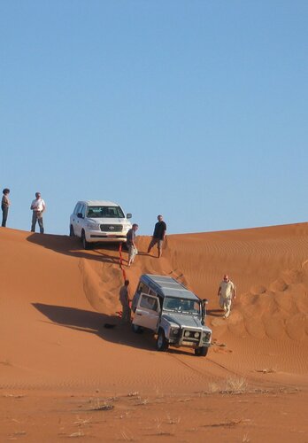 Das Eingraben der Fahrzeuge in den Sanddünen gehört zum Offroad fahren. Der Guide von 4x4 Exploring GmbH leitet die Bergung. Offroad Oman.  | © 4x4 Exploring GmbH